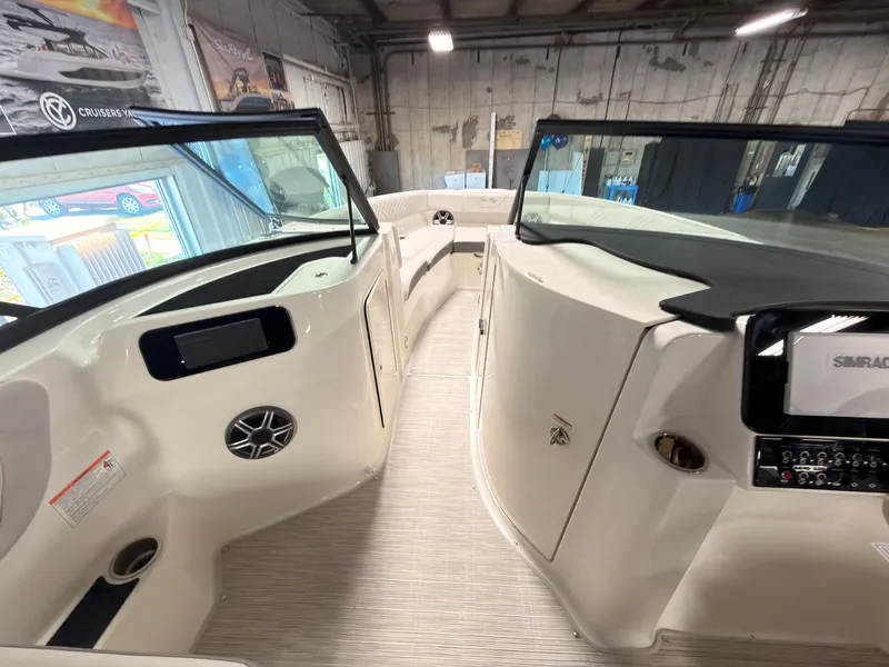 Slide: The Image of The image shows the cockpit of a 2026 Sea Ray SDX 230 Surf with modern instruments. - 41