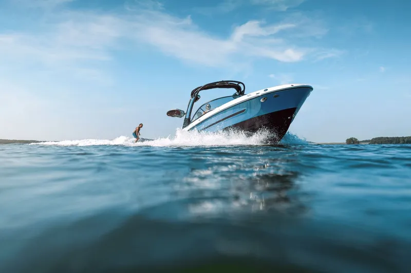 Slide: The Image of Sea Ray SDX 250 Surf 2026 on water with surfer. - 3