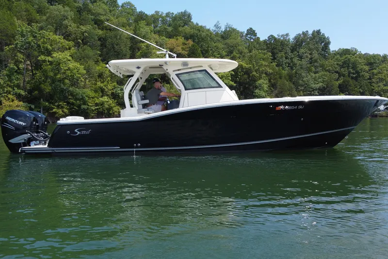 Slide: The Image of Interior of 2021 Scout 330 LXF boat featuring control panel and storage compartments. - 18