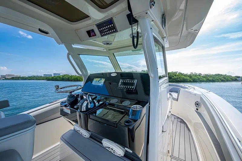 Slide: The Image of 2021 Scout 330 LXF boat cockpit with modern navigation system on calm water. - 23