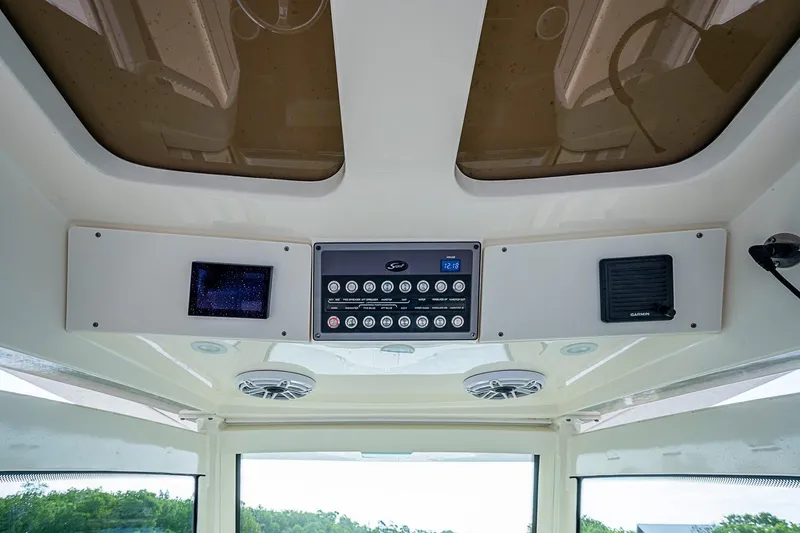 Slide: The Image of 2021 Scout 330 LXF boat dashboard with control panel and speakers. - 26