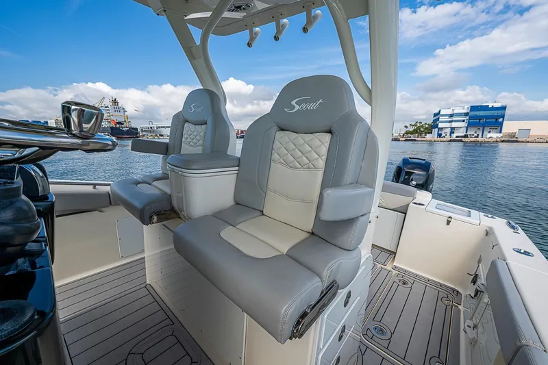Slide: The Image of 2021 Scout 330 LXF boat interior with luxurious seating and waterfront view. - 27