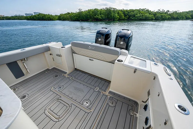 Slide: The Image of 2021 Scout 330 LXF boat deck with twin engines on calm water. - 31