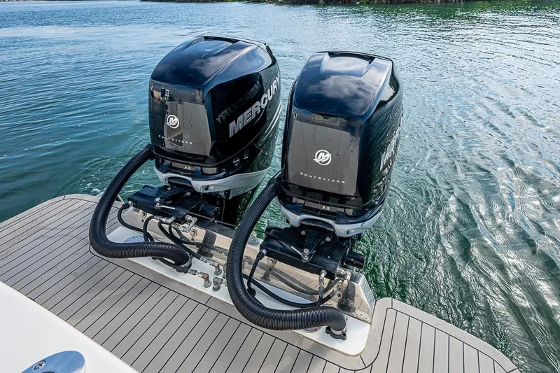 Slide: The Image of Twin Mercury outboard engines on a 2021 Scout 330 LXF boat, docked on water. - 37