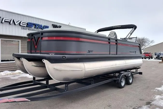 The Image of 2026 Viaggio x22u pontoon boat on trailer at dealership, featuring sleek design and modern features. - 0