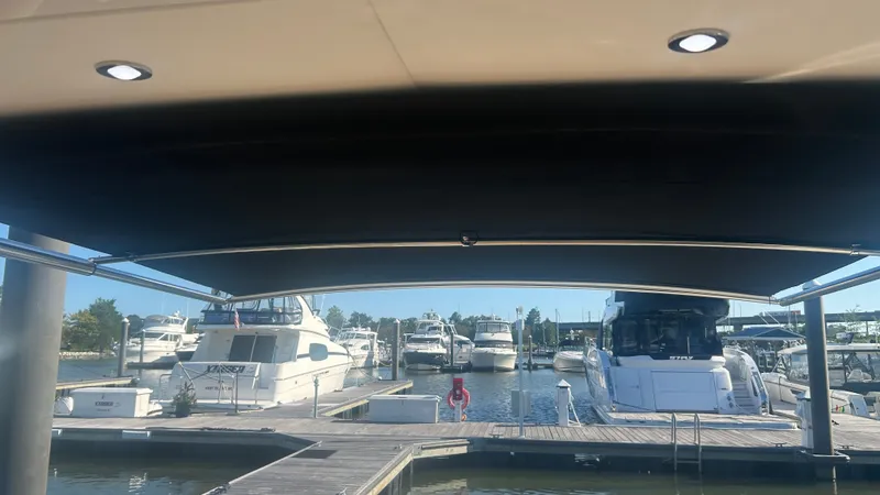 Slide: The Image of View from a boat overlooking a marina with several boats docked. - 17