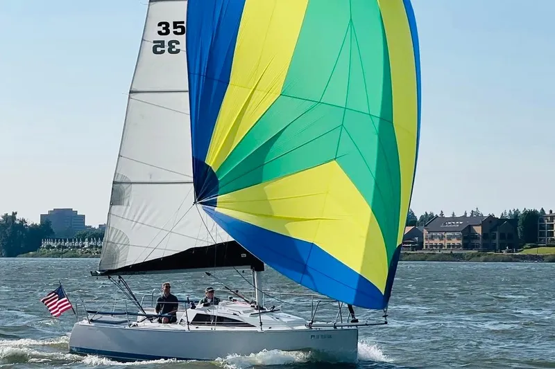 The Image of 2016 Catalina 275 Sport sailboat with colorful spinnaker on the water. - 0