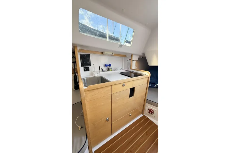 Slide: The Image of Interior of 2016 Catalina 275 Sport with wooden kitchen and window. - 5