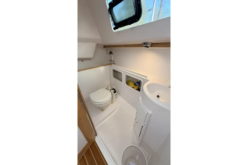 Slide: The Image of Interior of 2016 Catalina 275 Sport featuring toilet and sink. - 6