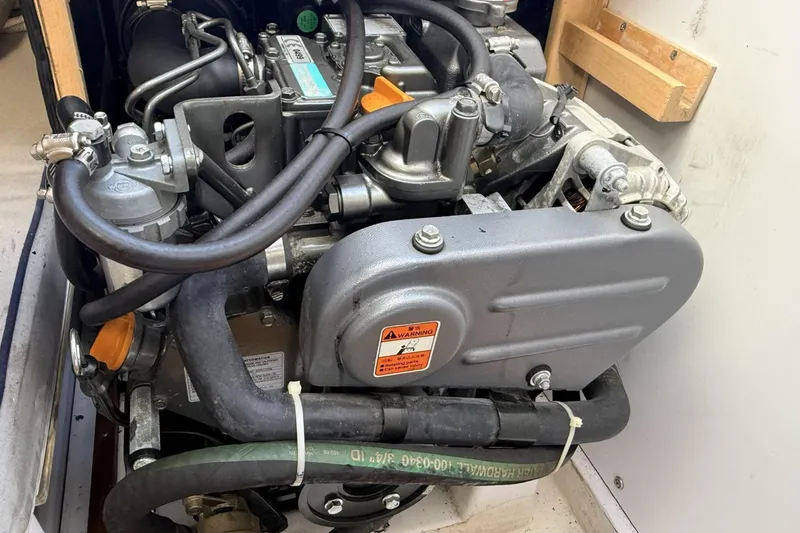 Slide: The Image of Engine of a 2016 Catalina 275 Sport with hoses and warning label. - 8