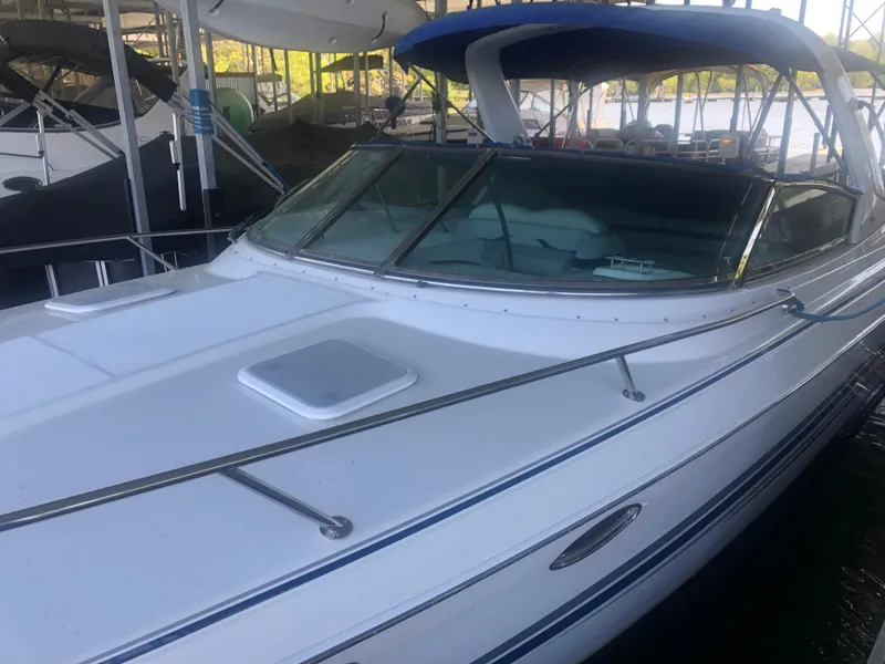 Slide: The Image of 2004 Formula 330 Sun Sport boat with blue canopy docked in marina. - 10