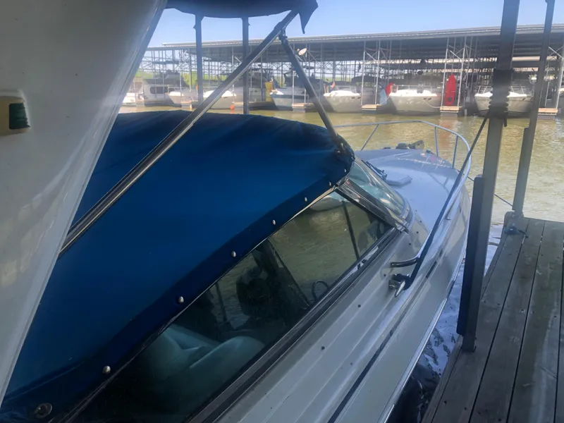 Slide: The Image of 2004 Formula 330 Sun Sport boat docked with blue canopy in marina. - 13