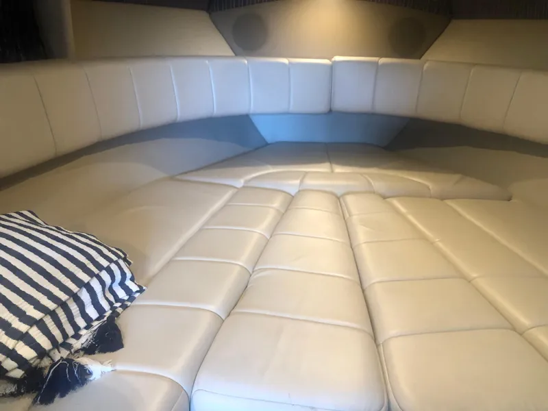 Slide: The Image of 2004 Formula 330 Sun Sport cabin interior with beige seating and striped pillow. - 30