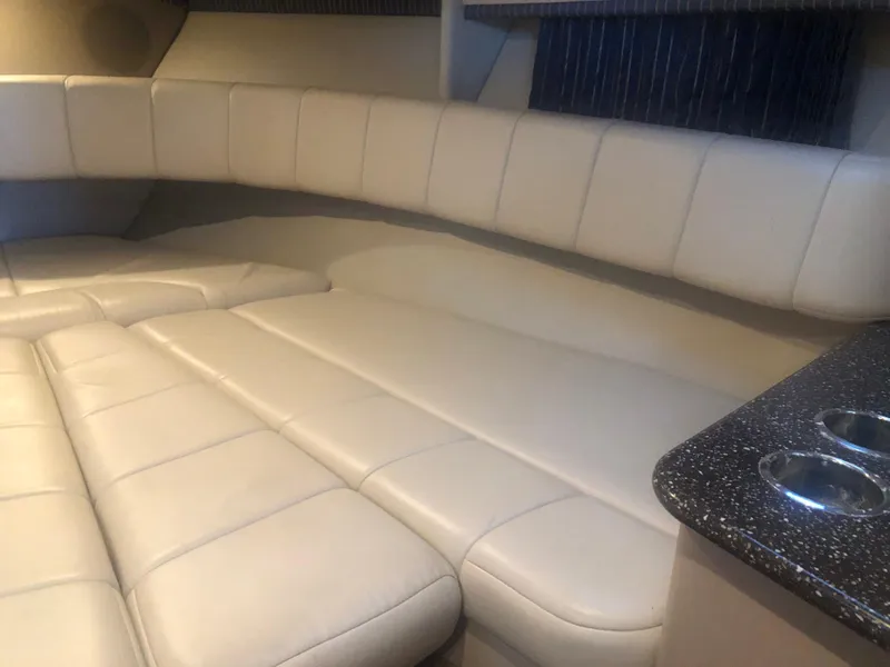 Slide: The Image of 2004 Formula 330 Sun Sport interior with beige leather seating and a black countertop. - 31