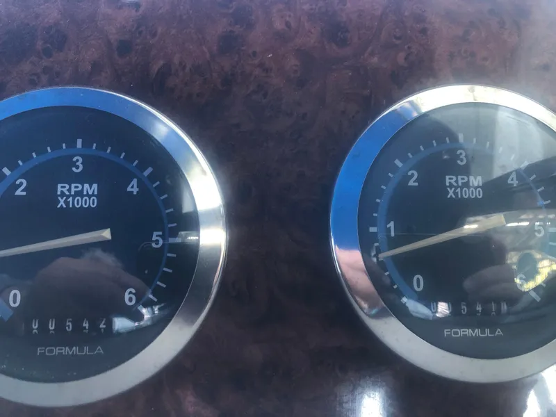 Slide: The Image of Close-up of RPM gauges on a 2004 Formula 330 Sun Sport boat dashboard. - 37