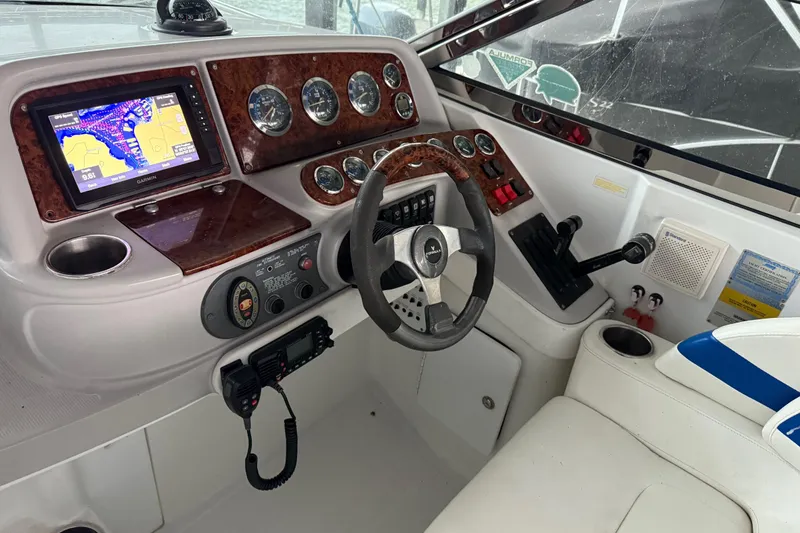 Slide: The Image of 2004 Formula 330 Sun Sport boat dashboard with navigation system and controls. - 46