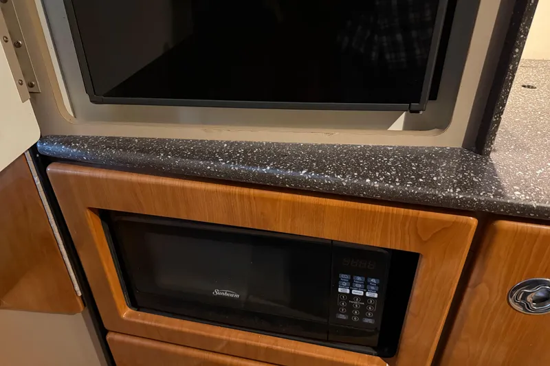 Slide: The Image of 2004 Formula 330 Sun Sport interior with microwave and storage cabinets. - 51