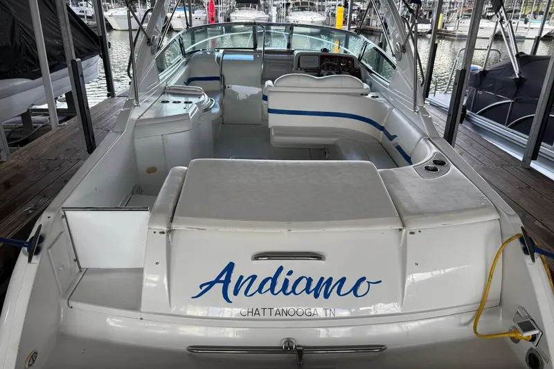 Slide: The Image of 2004 Formula 330 Sun Sport boat docked, featuring spacious seating and sleek design. - 55