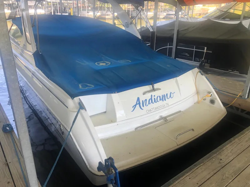 Slide: The Image of 2004 Formula 330 Sun Sport boat docked with blue cover and "Andiamo" on the stern. - 6