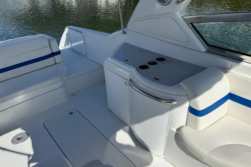 Slide: The Image of 2004 Formula 330 Sun Sport boat interior with white seating and blue accents. - 60