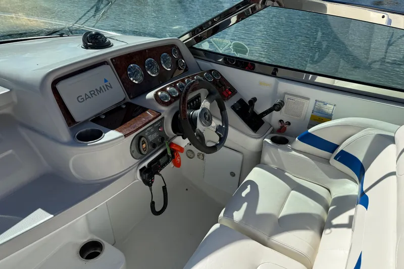 Slide: The Image of 2004 Formula 330 Sun Sport boat cockpit with Garmin navigation and white seating. - 61