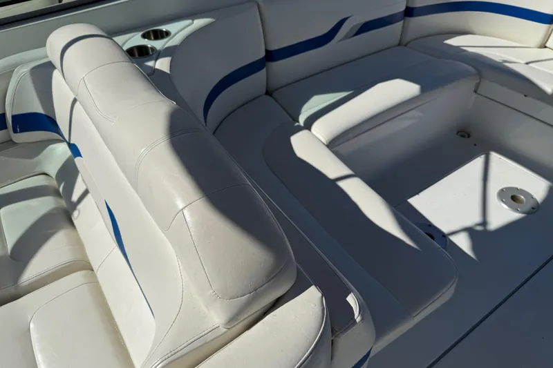 Slide: The Image of 2004 Formula 330 Sun Sport boat interior with white and blue seating. - 63