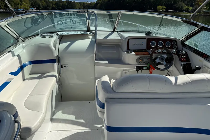 Slide: The Image of 2004 Formula 330 Sun Sport boat interior with Garmin navigation, white seating, and blue accents. - 70