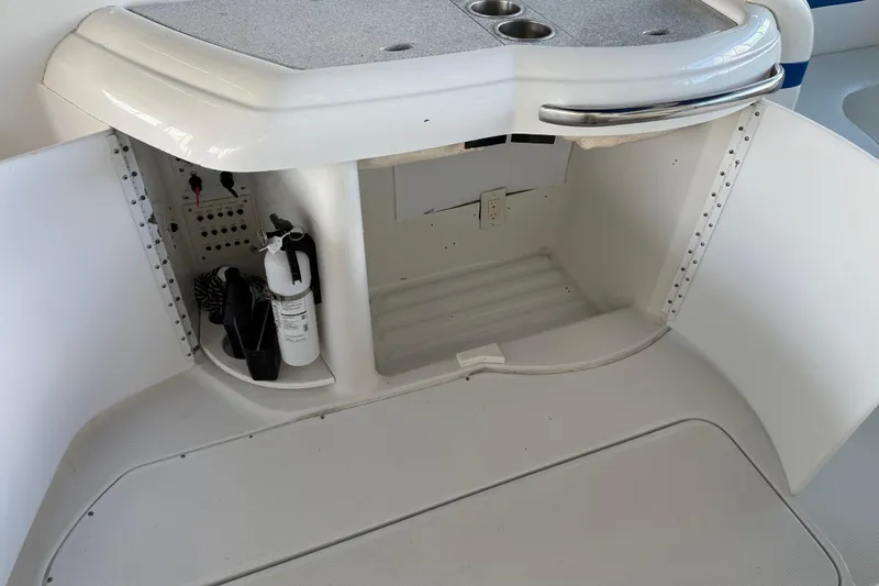 Slide: The Image of 2004 Formula 330 Sun Sport boat interior with storage and fire extinguisher. - 74