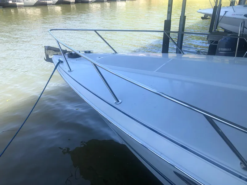 Slide: The Image of 2004 Formula 330 Sun Sport boat docked on calm water. - 9