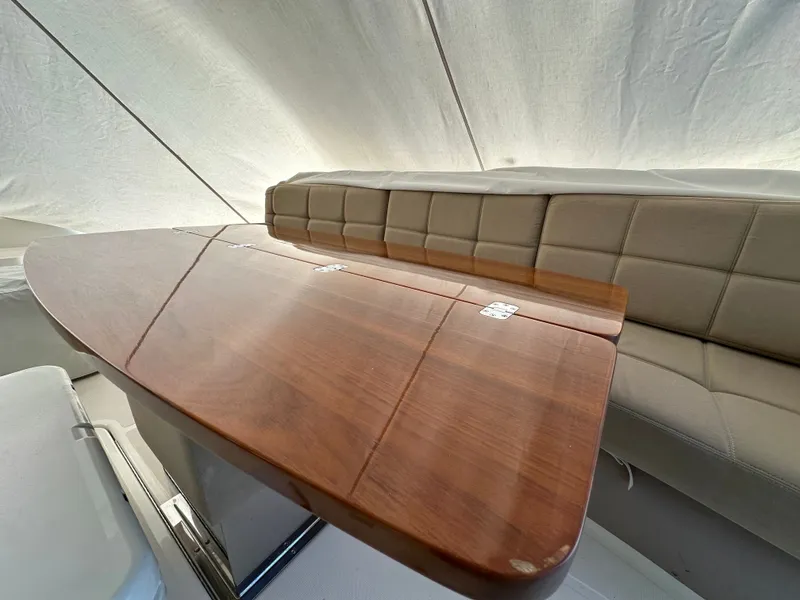 Slide: The Image of Interior of 2015 Tiara Yachts 50 Sports Coupe with wooden table. - 17
