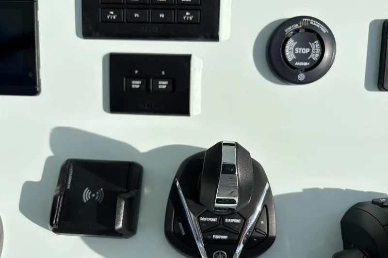Slide: The Image of Control panel of a 2024 Stuart 27 boat with controls. - 16