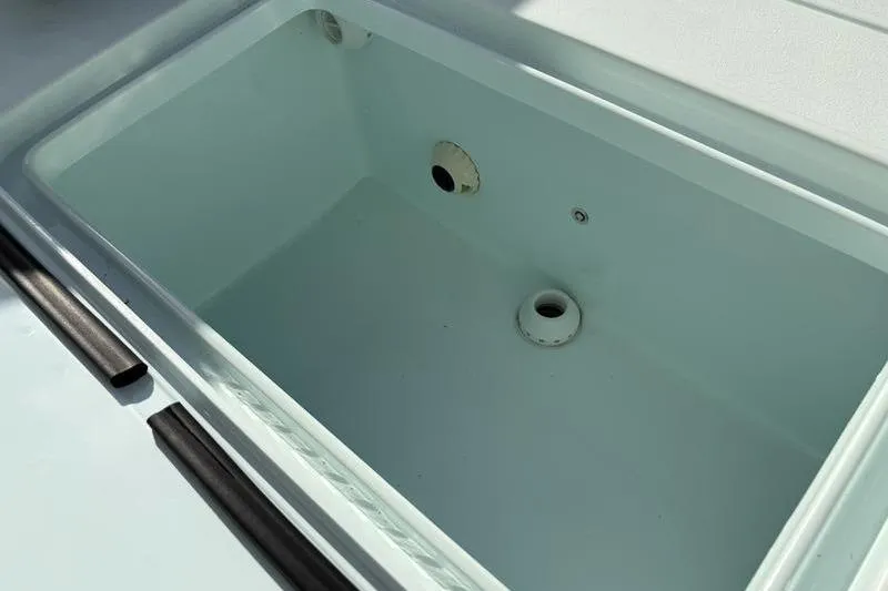 Slide: The Image of Empty storage compartment in Stuart 27 boat, 2024 model. - 23