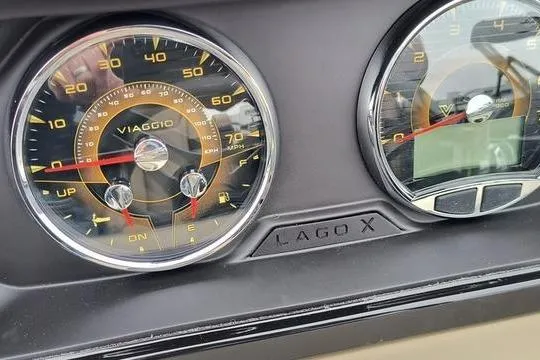 Slide: The Image of Dashboard of Viaggio x22u 2026 with speedometer and Lago X branding. - 10