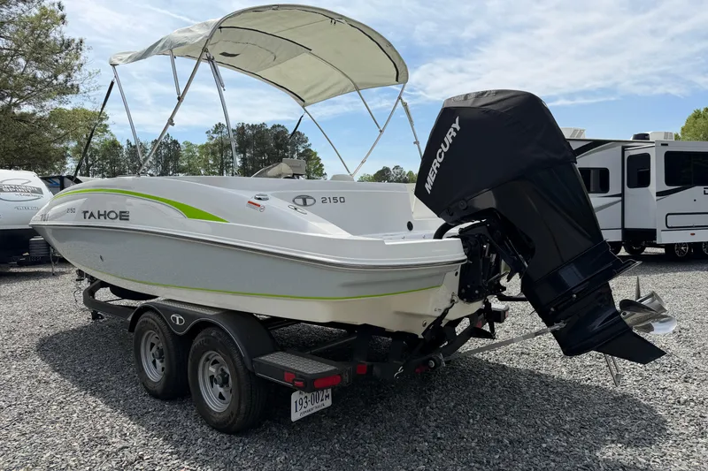 Slide: The Image of 2022 Tahoe 2150 boat with Mercury engine on trailer, parked outdoors. - 14