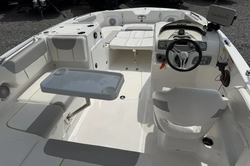 Slide: The Image of Interior of a 2022 Tahoe 2150 boat featuring seating, steering wheel, and Garmin navigation system. - 17