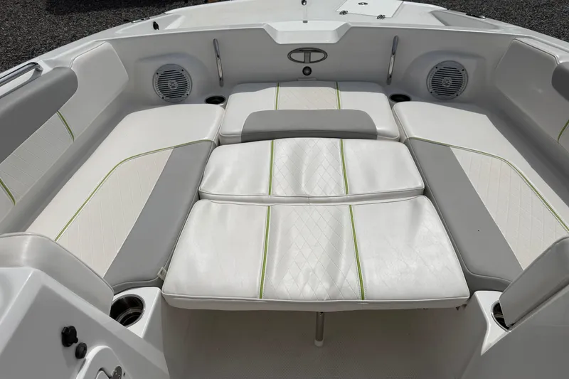 Slide: The Image of 2022 Tahoe 2150 boat interior with white cushioned seating and integrated speakers. - 19