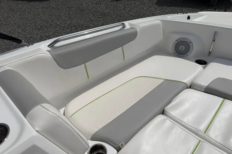 Slide: The Image of 2022 Tahoe 2150 boat interior with white and gray seating, green accents, and speaker. - 22