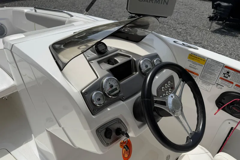 Slide: The Image of 2022 Tahoe 2150 boat dashboard with steering wheel and gauges. - 23