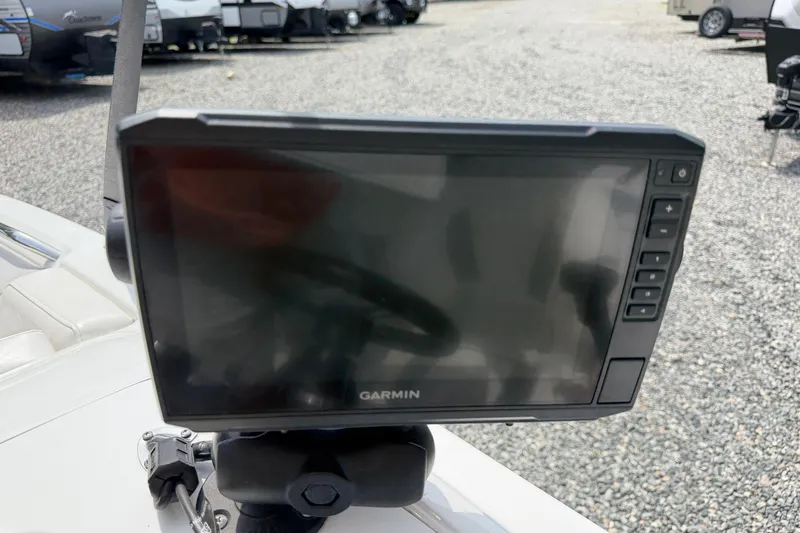 Slide: The Image of Garmin display on 2022 Tahoe 2150 boat, parked on gravel lot. - 25