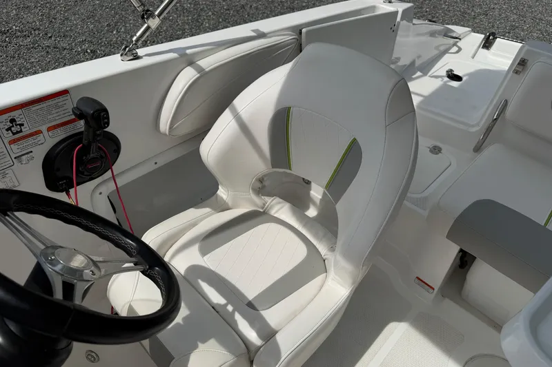 Slide: The Image of 2022 Tahoe 2150 boat interior with white seating and steering wheel. - 27