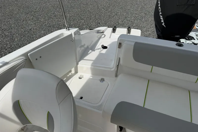 Slide: The Image of 2022 Tahoe 2150 boat interior with white and gray seating, featuring green accents. - 28