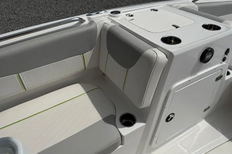 Slide: The Image of 2022 Tahoe 2150 boat interior with cushioned seating and storage compartments. - 30