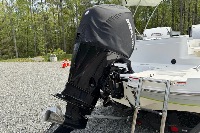Slide: The Image of 2022 Tahoe 2150 boat with Mercury outboard motor in a wooded area. - 35