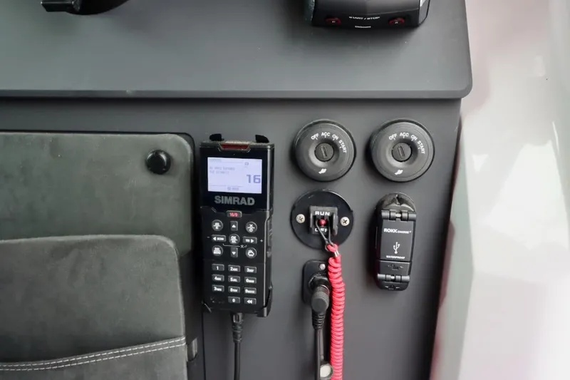 Slide: The Image of Control panel of 2022 Axopar 37 XC Cross Cabin with Simrad radio and USB charger. - 13