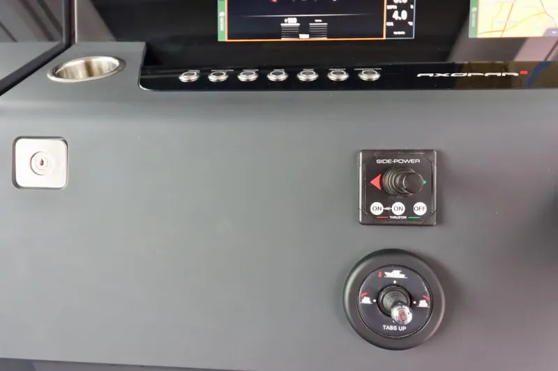 Slide: The Image of Control panel of 2022 Axopar 37 XC Cross Cabin with side-power and trim tab controls. - 14