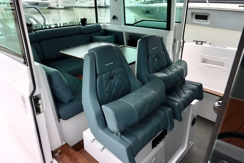 Slide: The Image of Interior of 2022 Axopar 37 XC Cross Cabin with luxurious seating and table. - 17