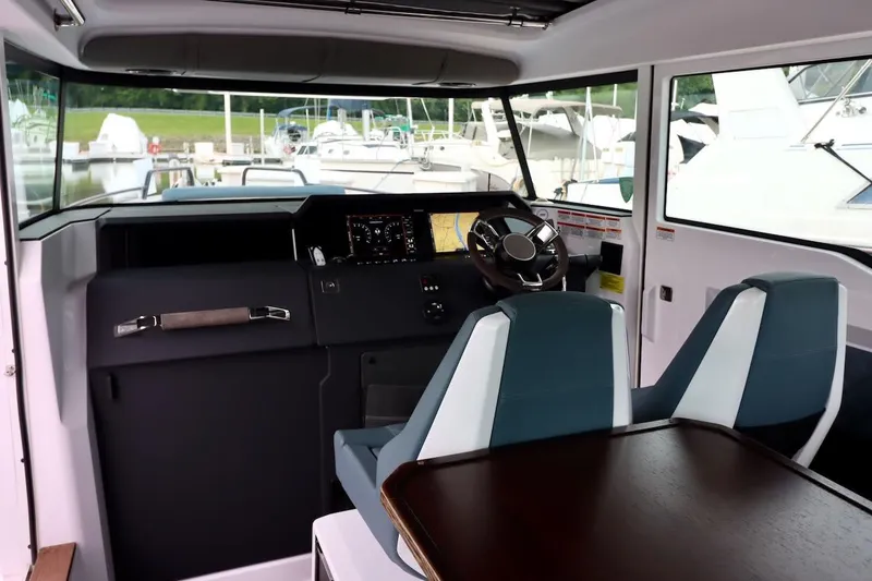 Slide: The Image of Interior of 2022 Axopar 37 XC Cross Cabin with modern dashboard and seating. - 22
