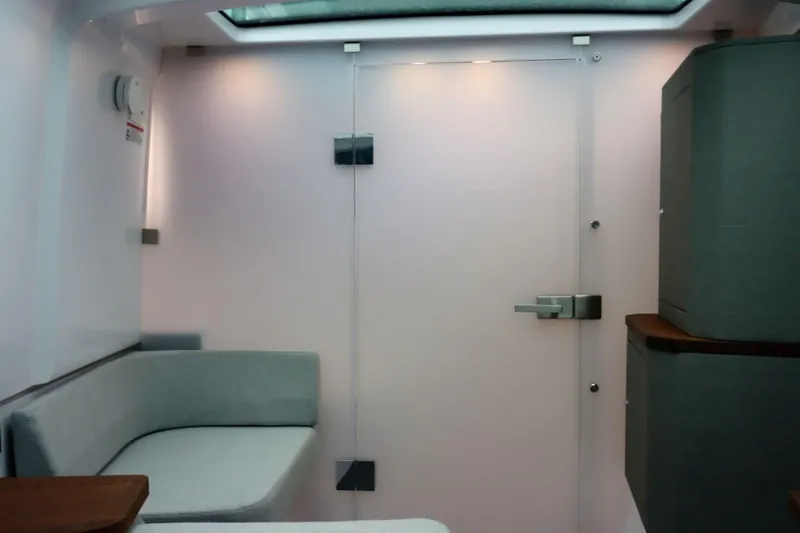 Slide: The Image of Interior of 2022 Axopar 37 XC Cross Cabin, featuring modern seating and sleek design. - 33