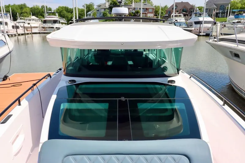 Slide: The Image of 2022 Axopar 37 XC Cross Cabin docked at a marina, showcasing sleek design. - 35