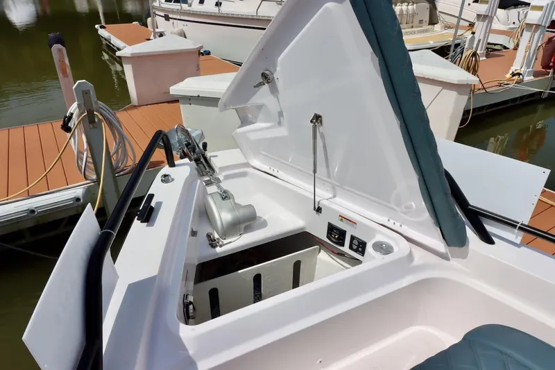 Slide: The Image of 2022 Axopar 37 XC Cross Cabin boat with open storage compartment at dock. - 40